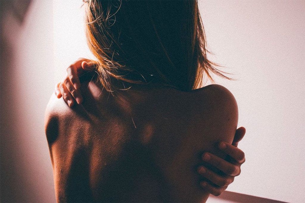 Woman massaging her own back