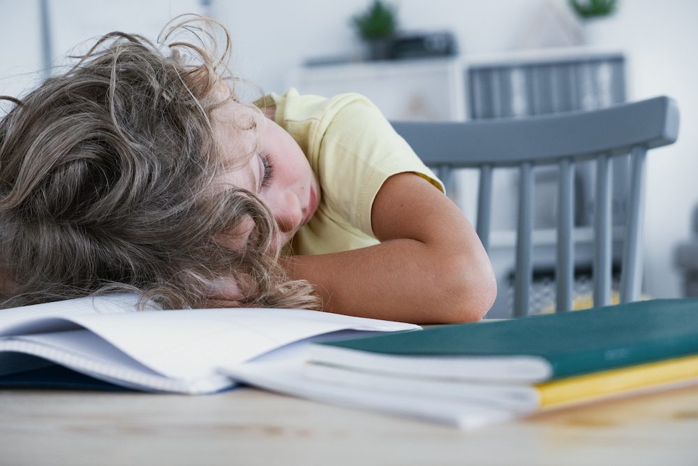 stock photo of a child with ADHD asleep at a dask