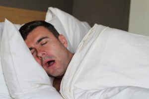 stock photo of a man sleeping with his mouth open