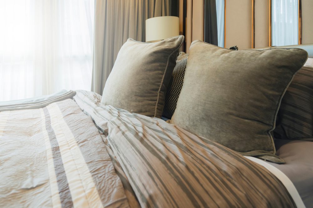 stock photo of a bed with pillows and a comforter on top of it