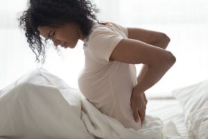 stock photo of a woman in bed with period cramps