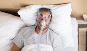 stock photo of a man sleeping with a cpap machine